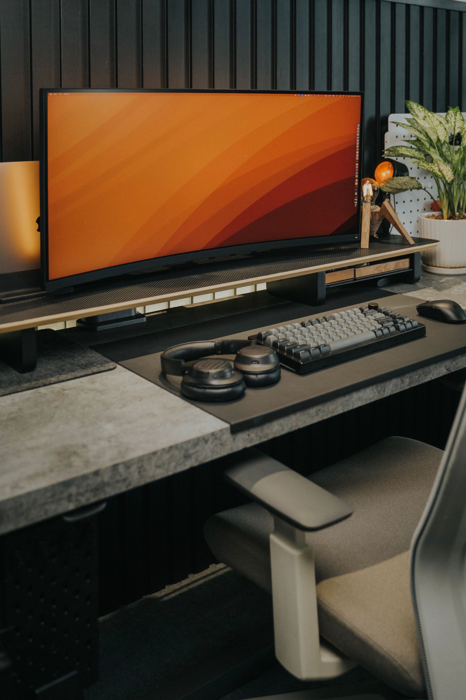 Gaming monitor headphones and mechanical keyboard arranged on a modern gaming desk
