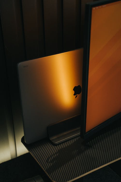 Free A macbook pro and an apple tv on a desk Stock Photo