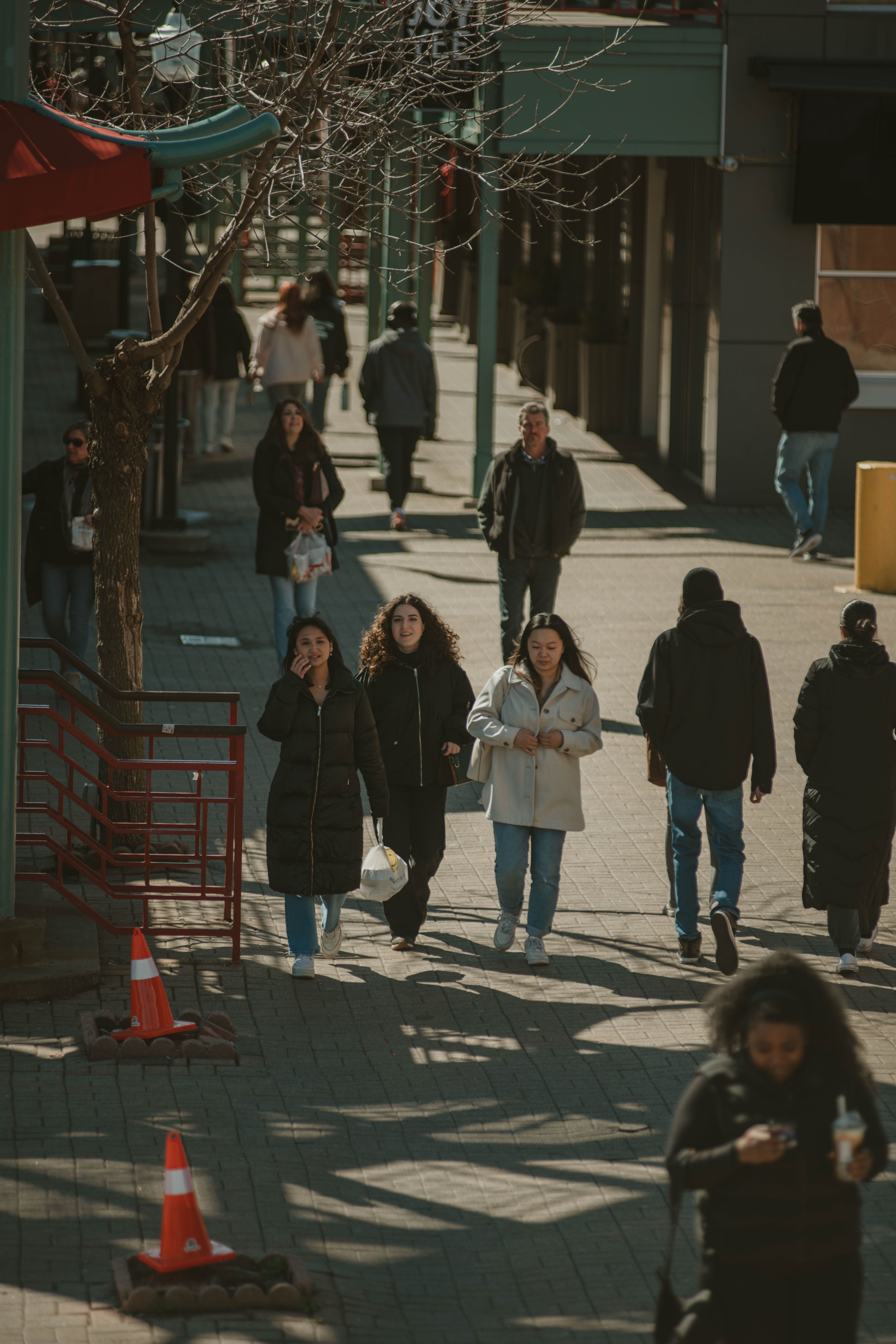 People in Jackets Walking on Sidewalk · Free Stock Photo