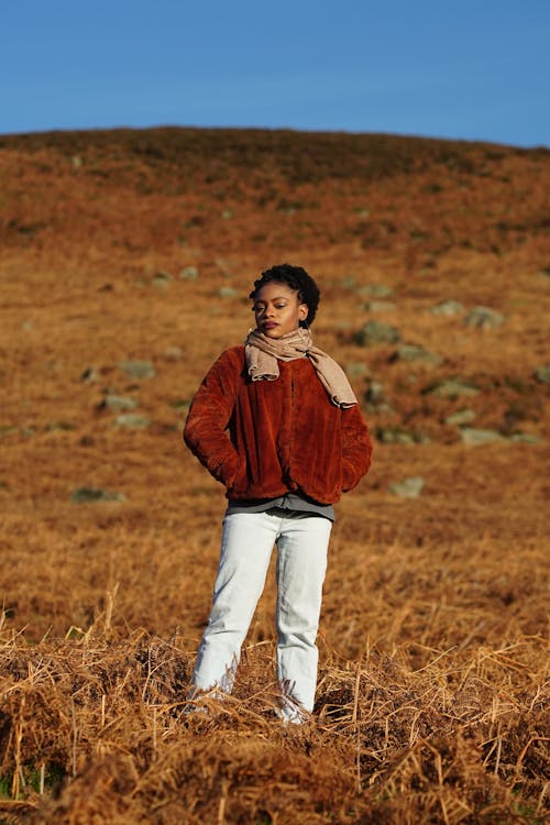 Woman in Jacket and Scarf on Field