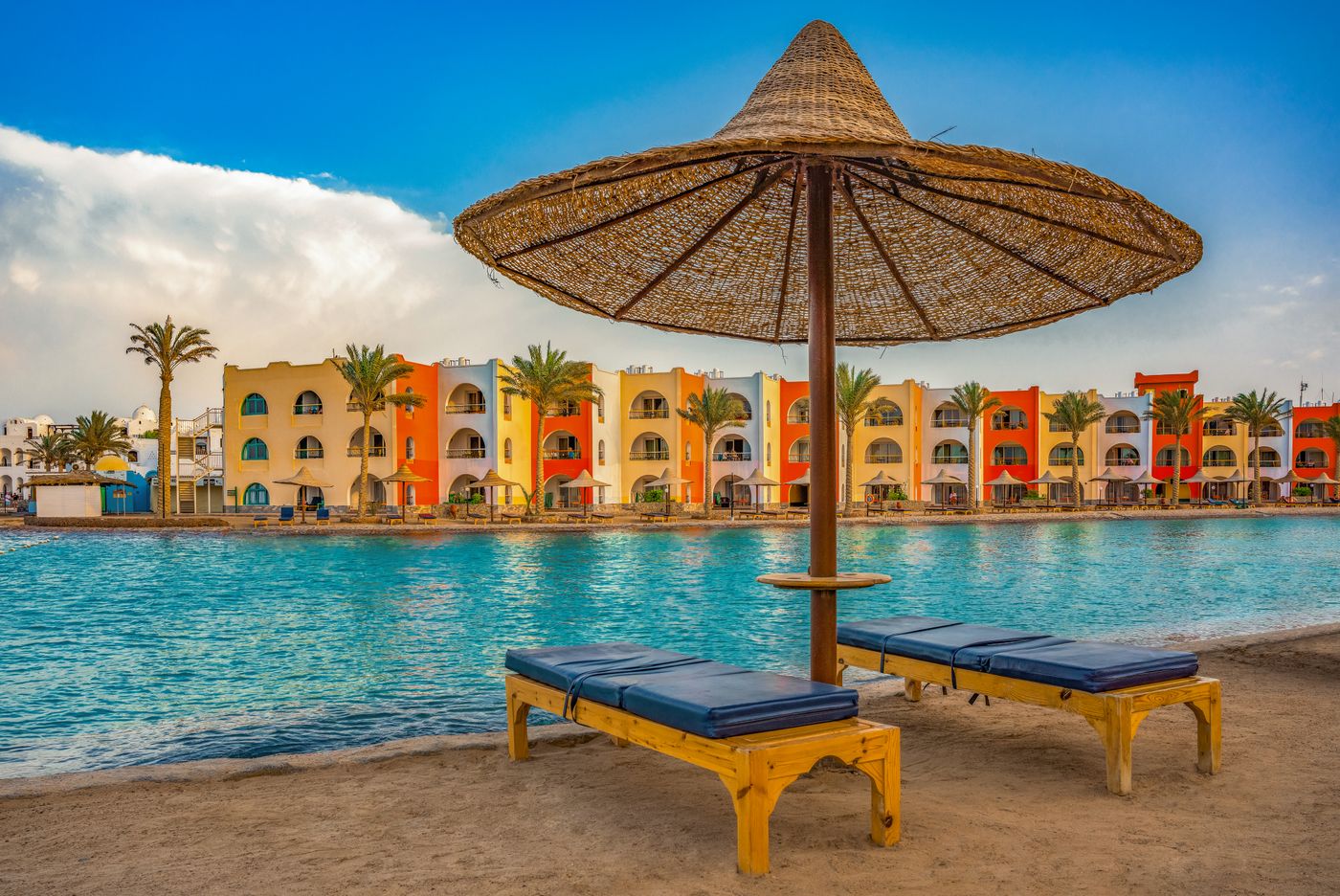 Sunbeds and umbrella by the swimming pool