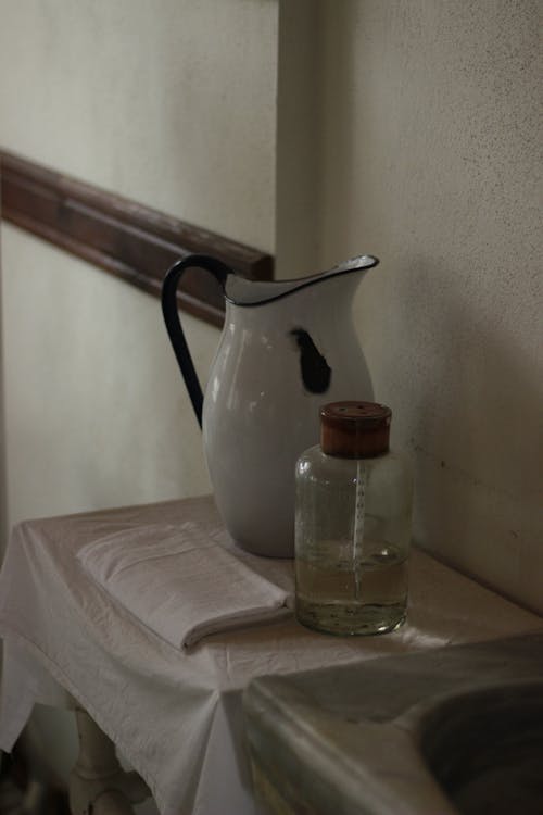 A pitcher and a glass on a table