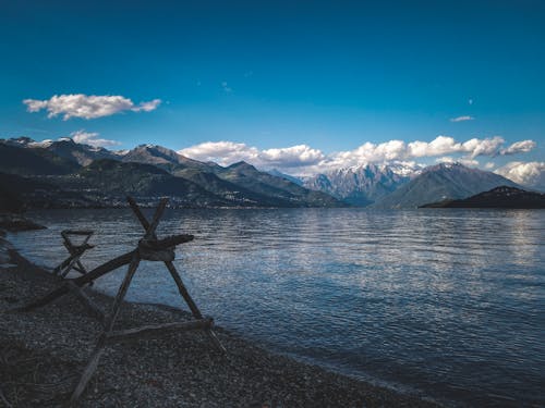 A bench on the beach with mountains in the background