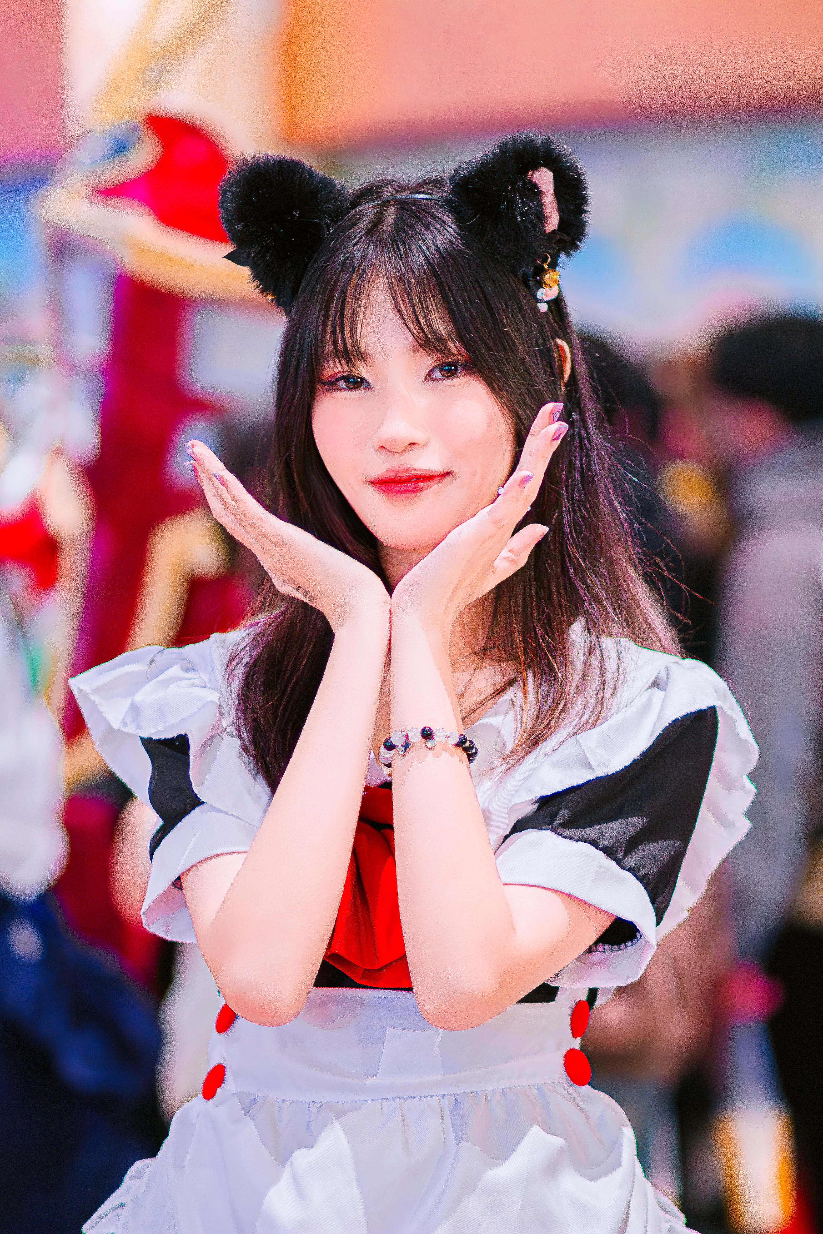 Vibrant cosplay portrait of a woman with cat ears, showcasing anime culture at a festival.