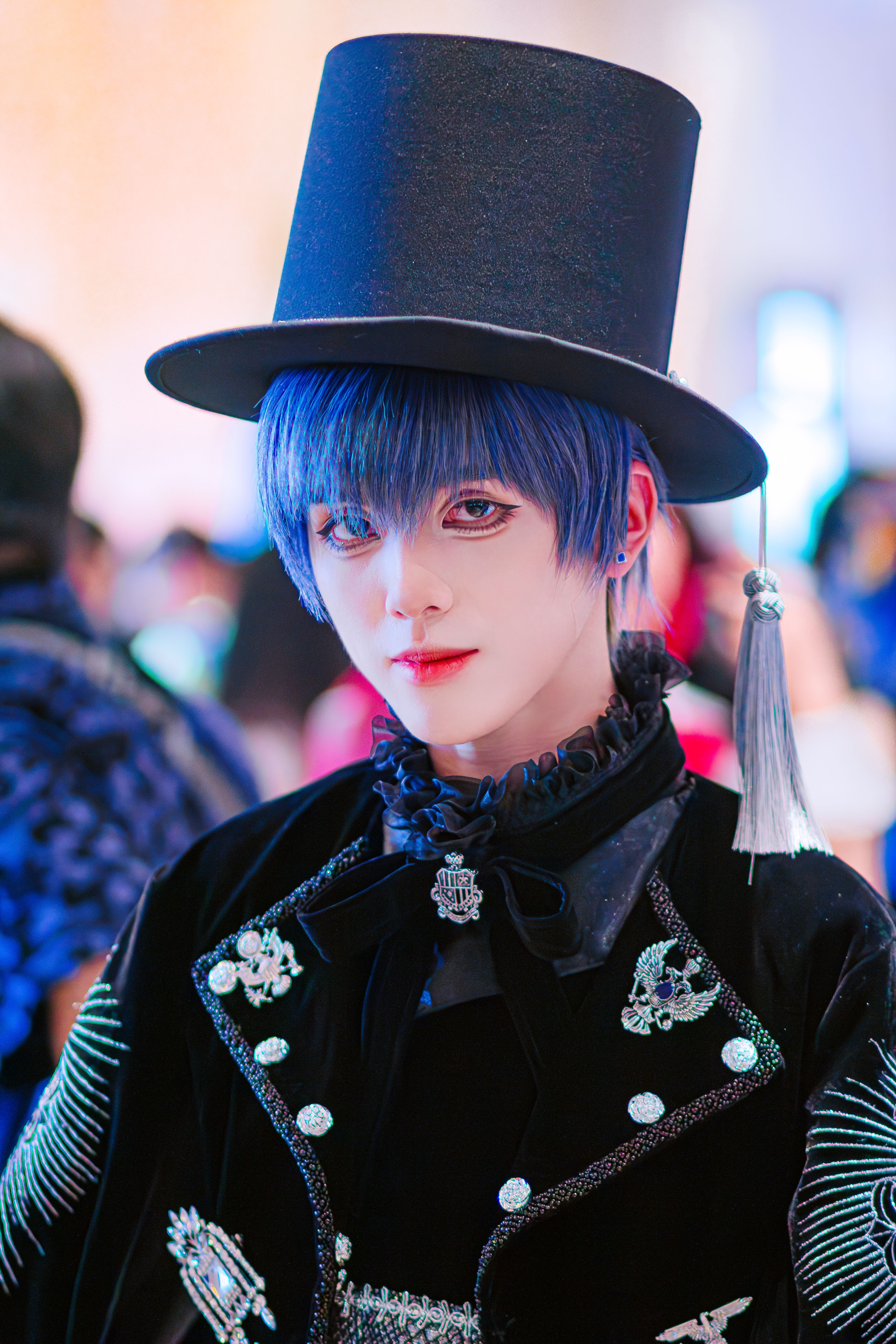 A vibrant cosplay character in a detailed costume and top hat, showcasing anime style.