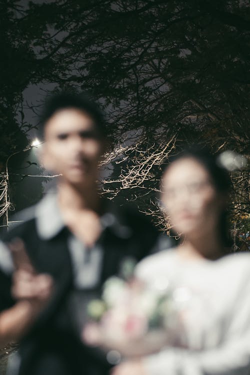 A couple standing in front of a tree