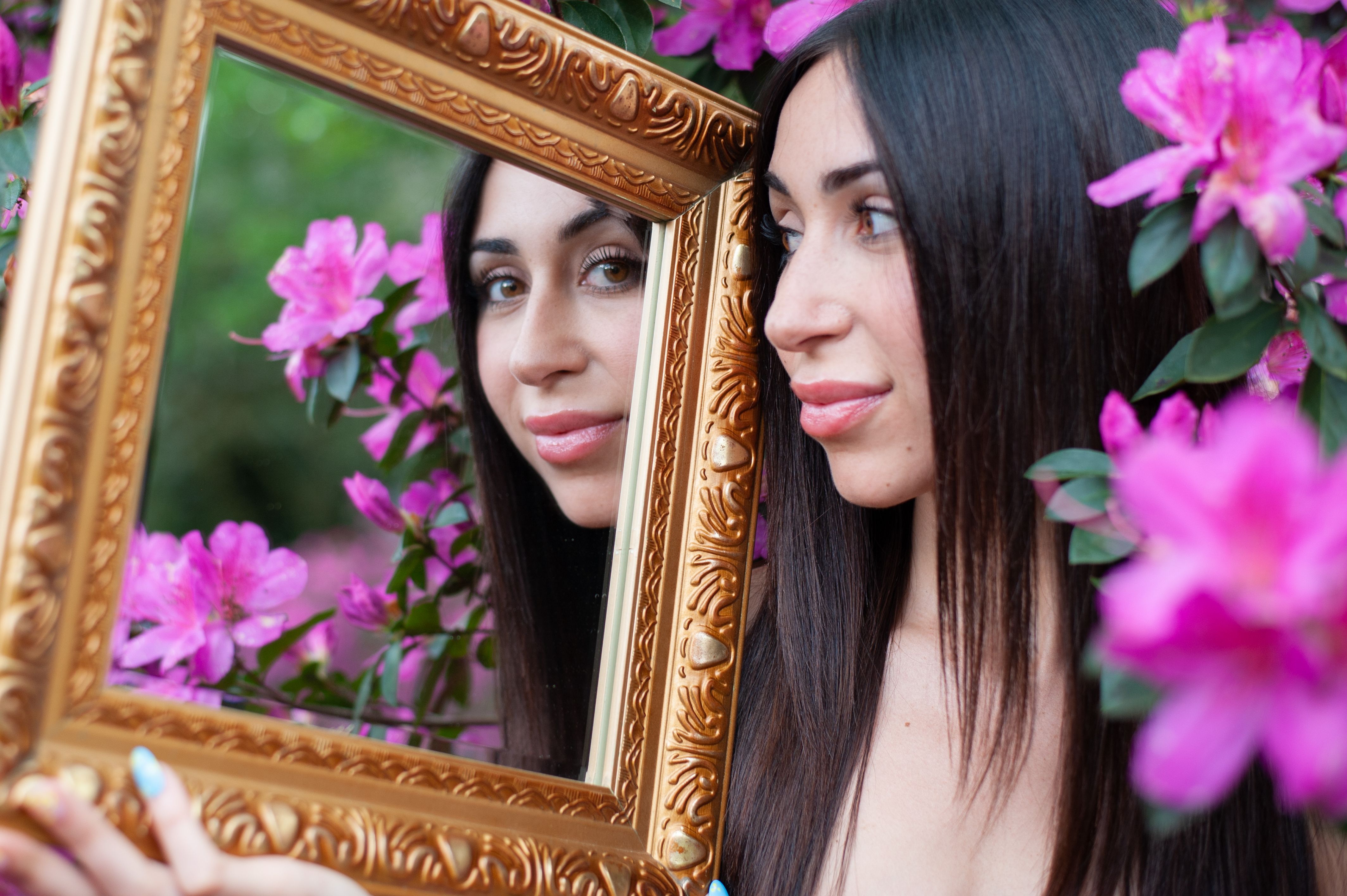Woman with Blooming Pink Flowers Fooking in the Mirror · Free Stock Photo