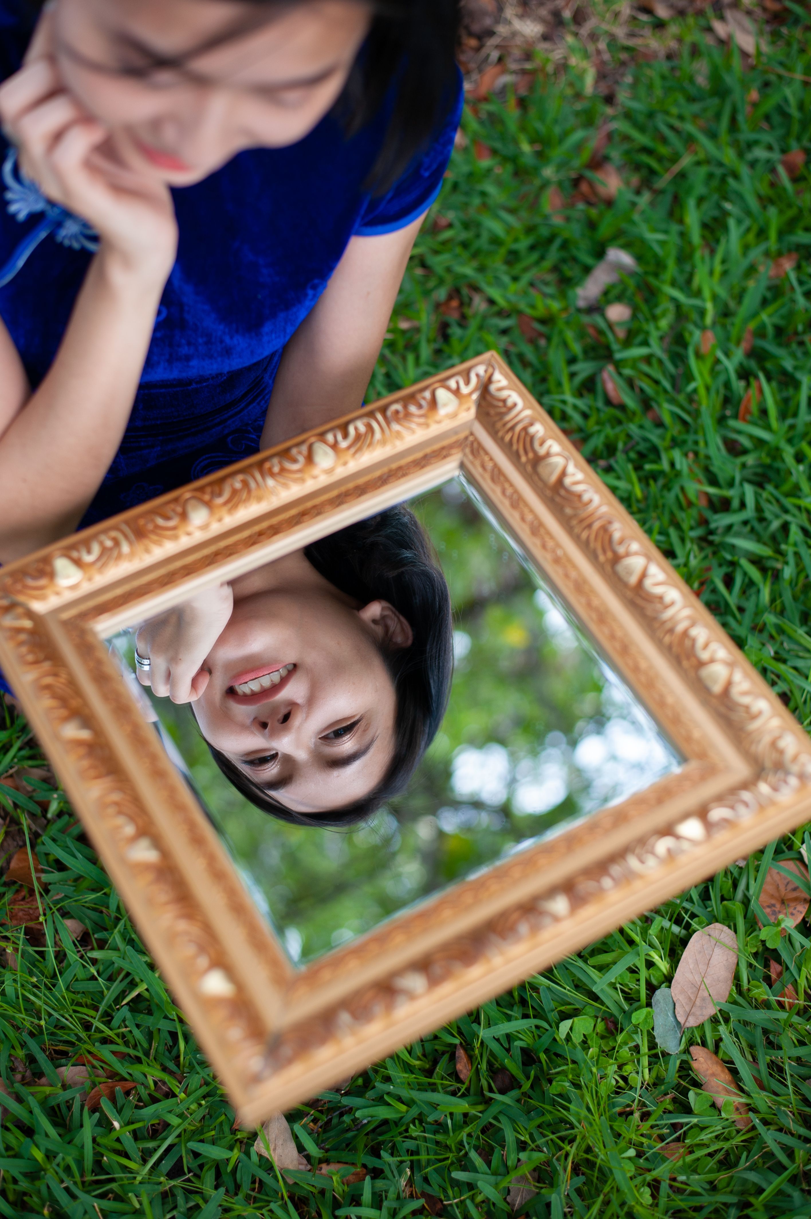 Woman Looking at Her Reflection in a Mirror · Free Stock Photo