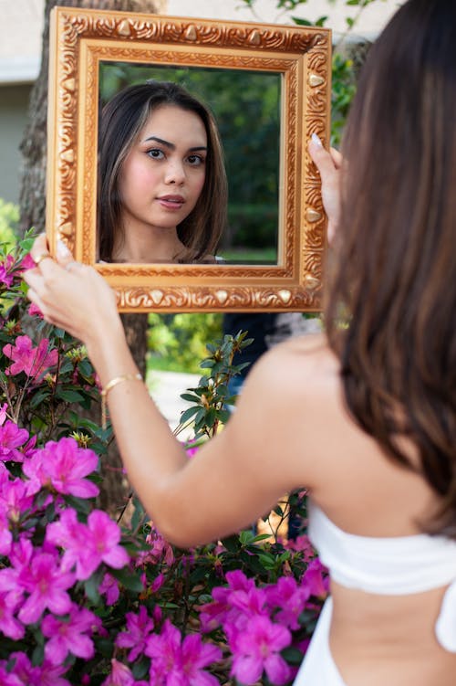 Woman Standing and Holding Golden Mirror