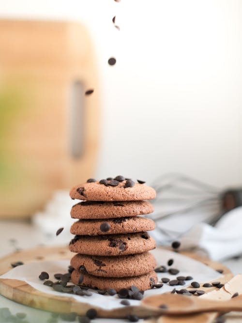A stack of chocolate chip cookies with a sprinkle of chocolate chips