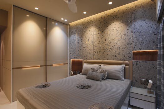 A chic modern bedroom featuring a stylish contemporary design with ambient lighting and sleek furniture.
