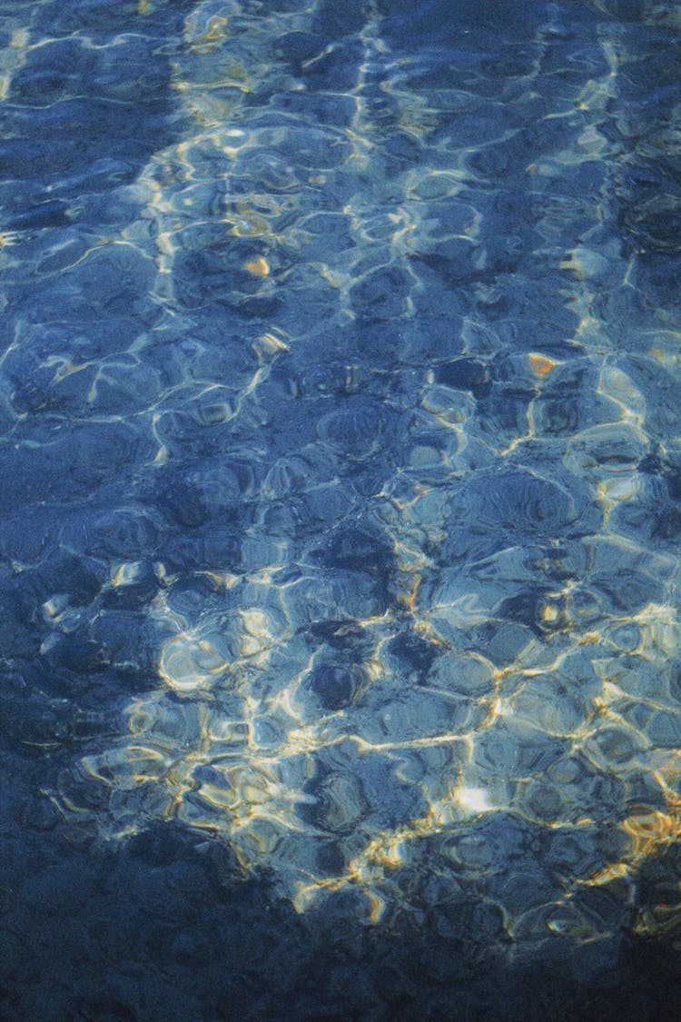 Blue Water With Ripples And Reflections