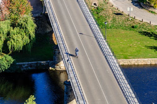 A Cyclist Riding over a Bridge
