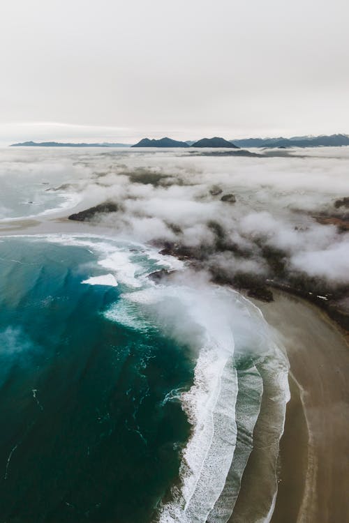 Aerial view of the ocean and clouds over a beach