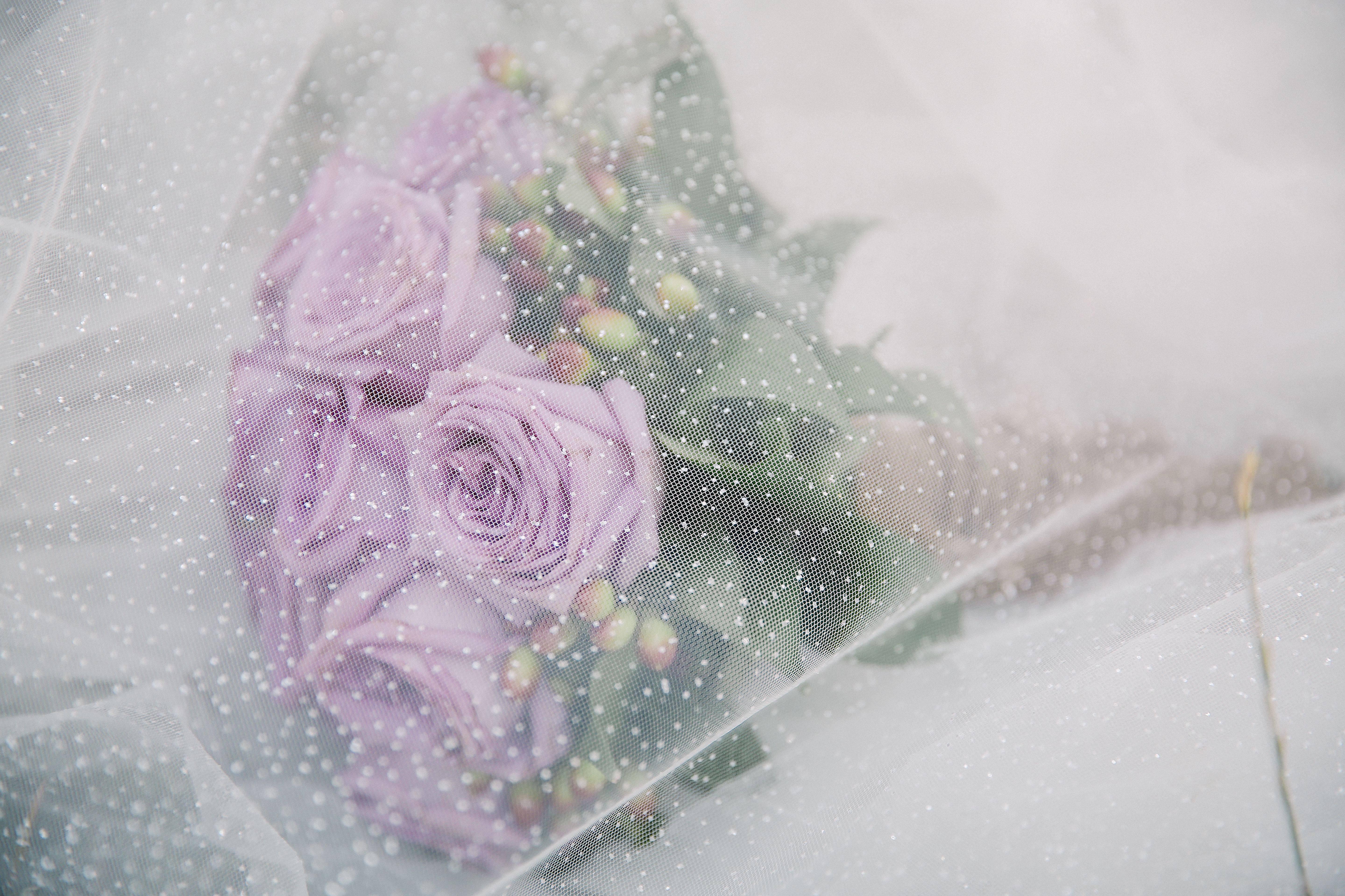 Close-up of bridal details including flowers and jewellery