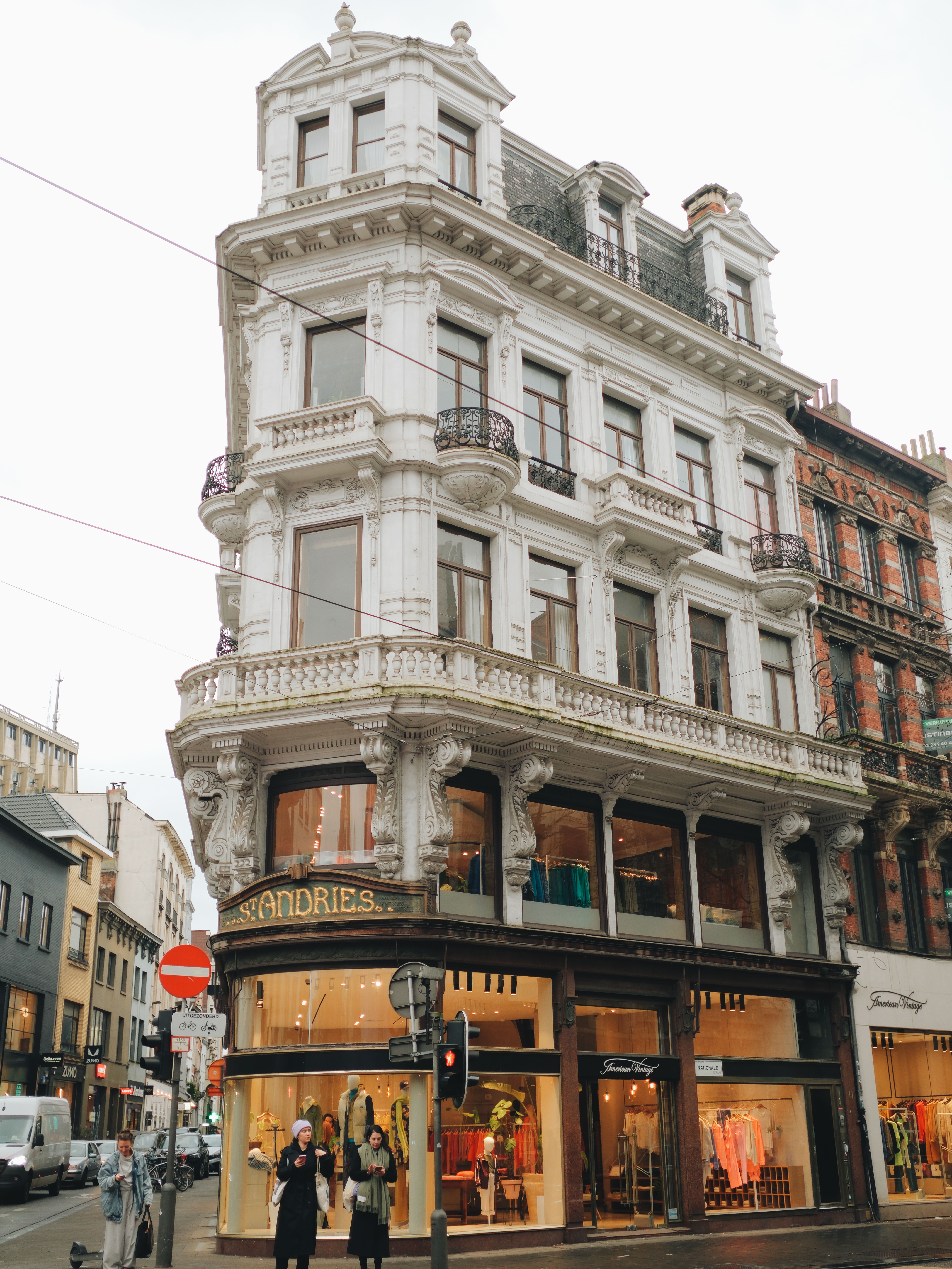Charming corner townhouse in Brugge featuring luxurious boutique shopfronts.