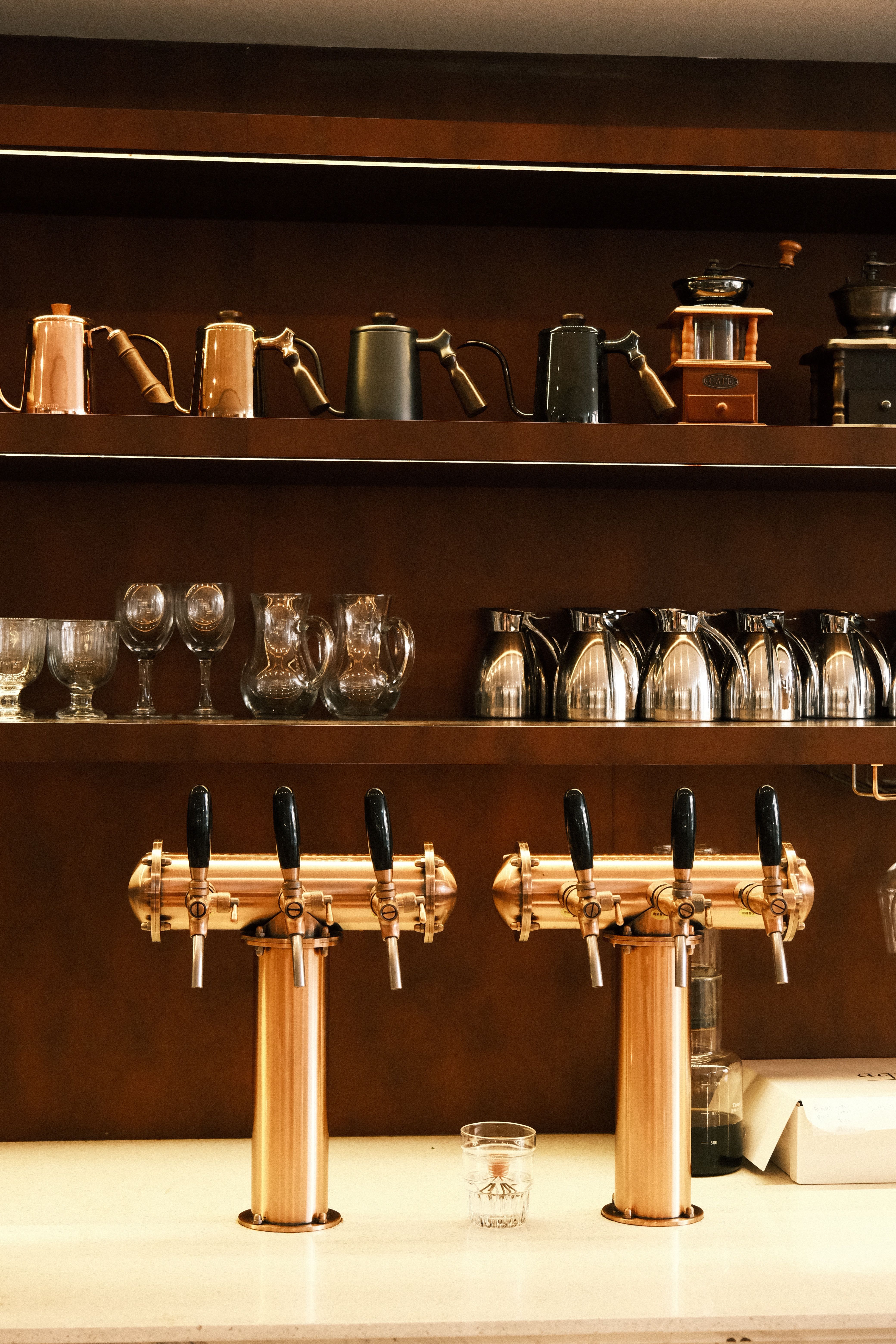 Row of craft beer taps along the bar counter at Cru Bar Dining