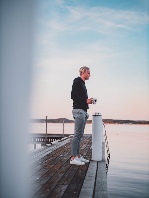 Man Standing On Wooden Dock