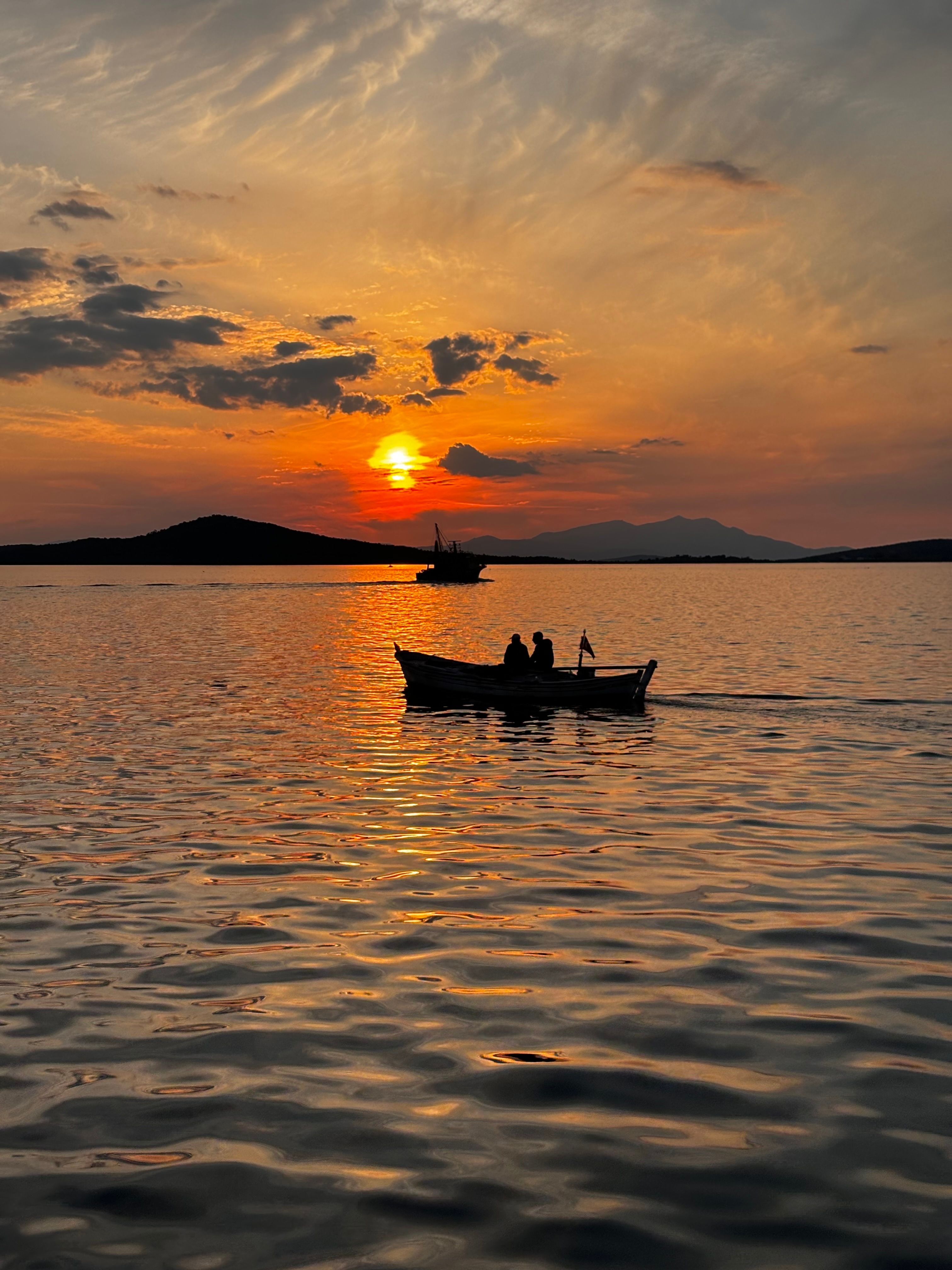 Silhouette of Boat in Sea During Sunset · Free Stock Photo