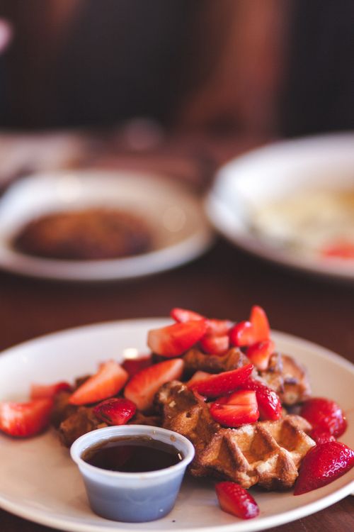 Free Indulge in delicious waffles topped with fresh strawberries and syrup. Stock Photo