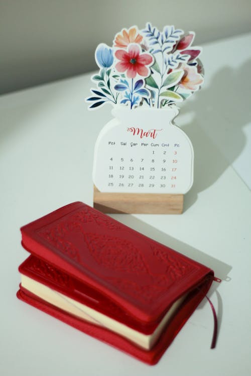 Red Notebook next to a Calendar