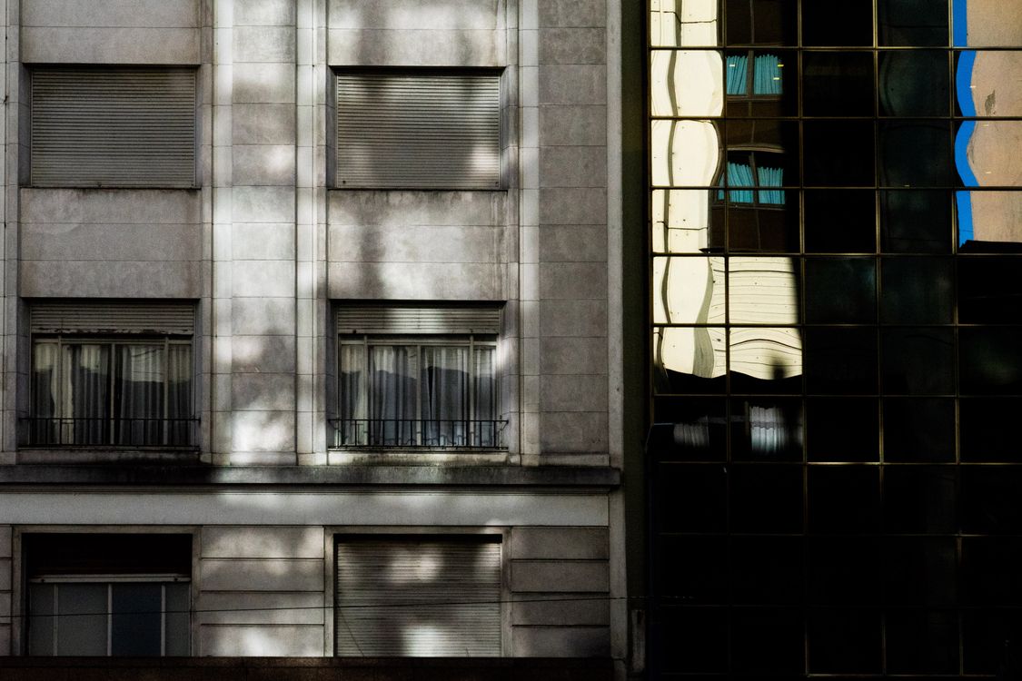 Building In Shadow Glass and Stone Buildings in Shadow · Free Stock Photo