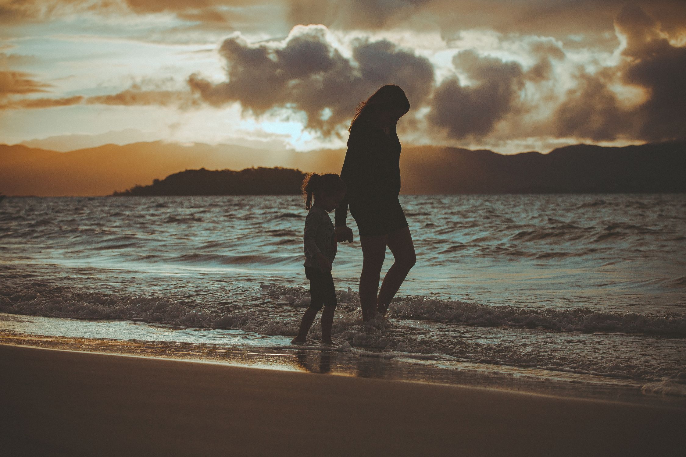 Silhouette Of Woman And Girl Walking On Seashore · Free Stock Photo
