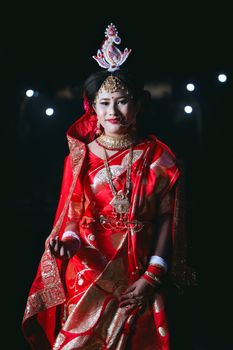 A woman dressed in vibrant traditional attire, showcasing cultural richness and elegance.