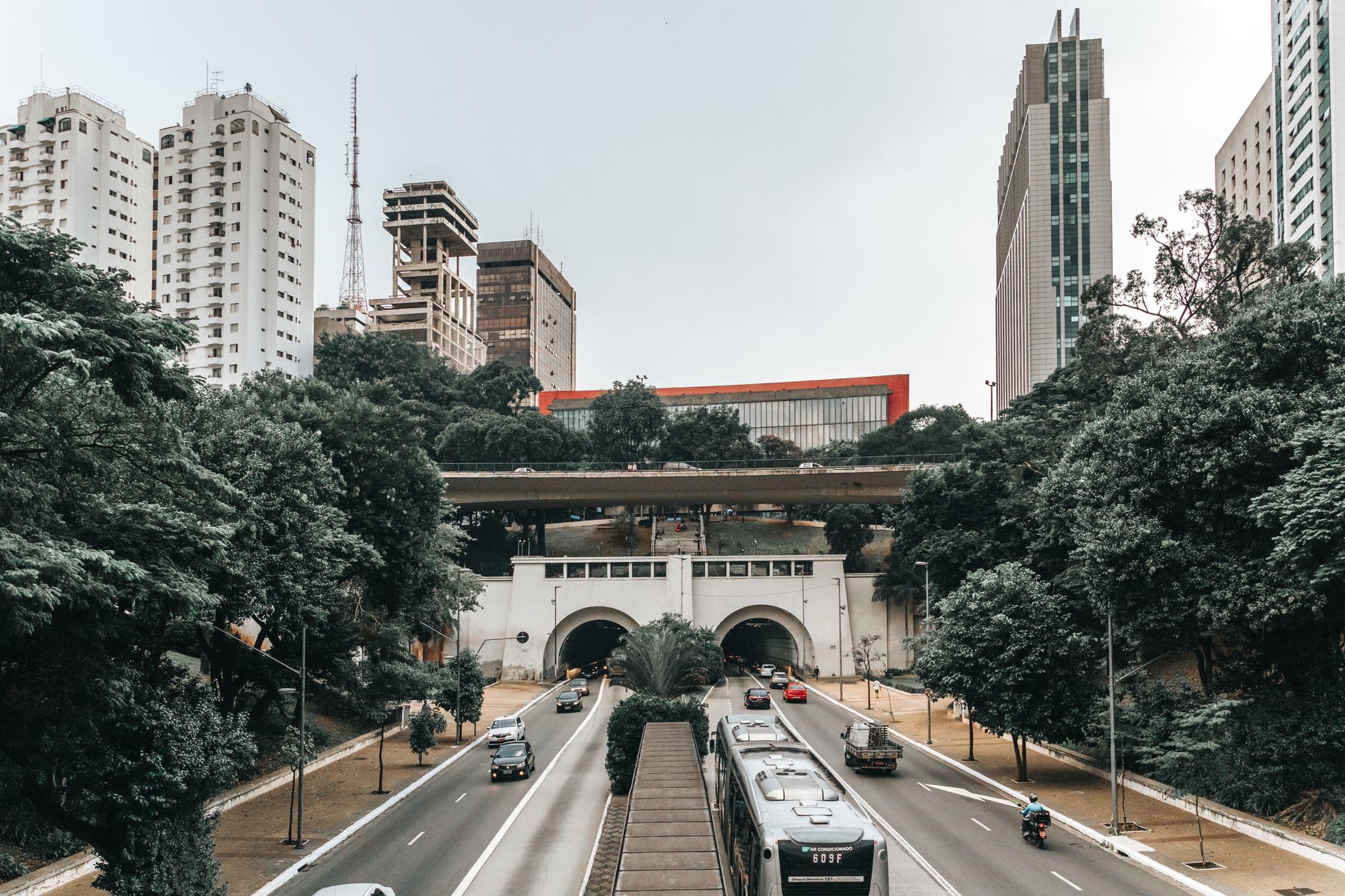 Dynamic São Paulo cityscape featuring iconic skyscrapers and a bustling highway tunnel.