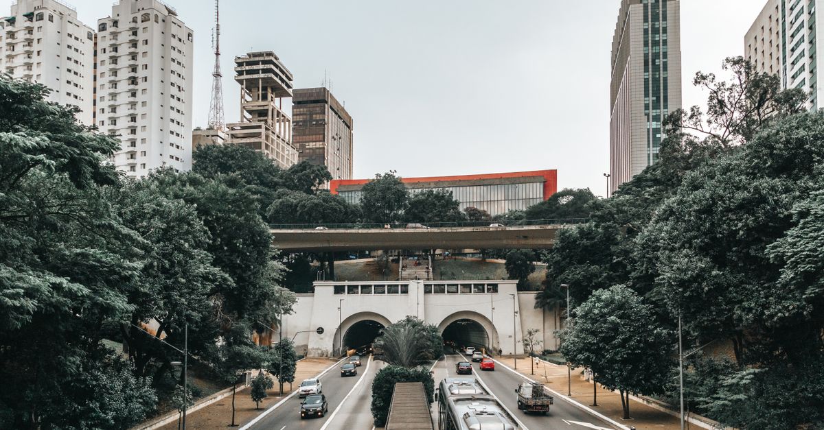 Dynamic São Paulo cityscape featuring iconic skyscrapers and a bustling highway tunnel.