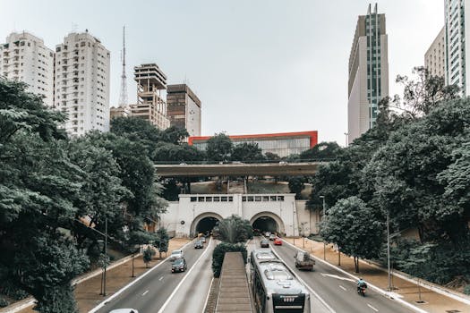 Dynamic São Paulo cityscape featuring iconic skyscrapers and a bustling highway tunnel.