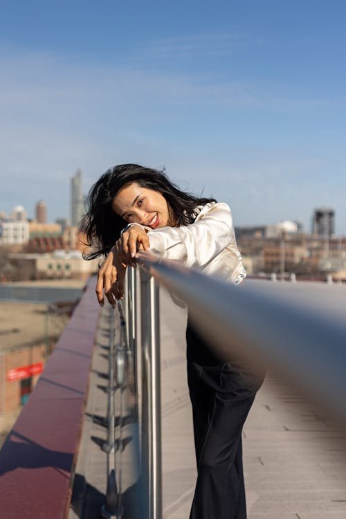 Smiling Woman Leaning on Railing