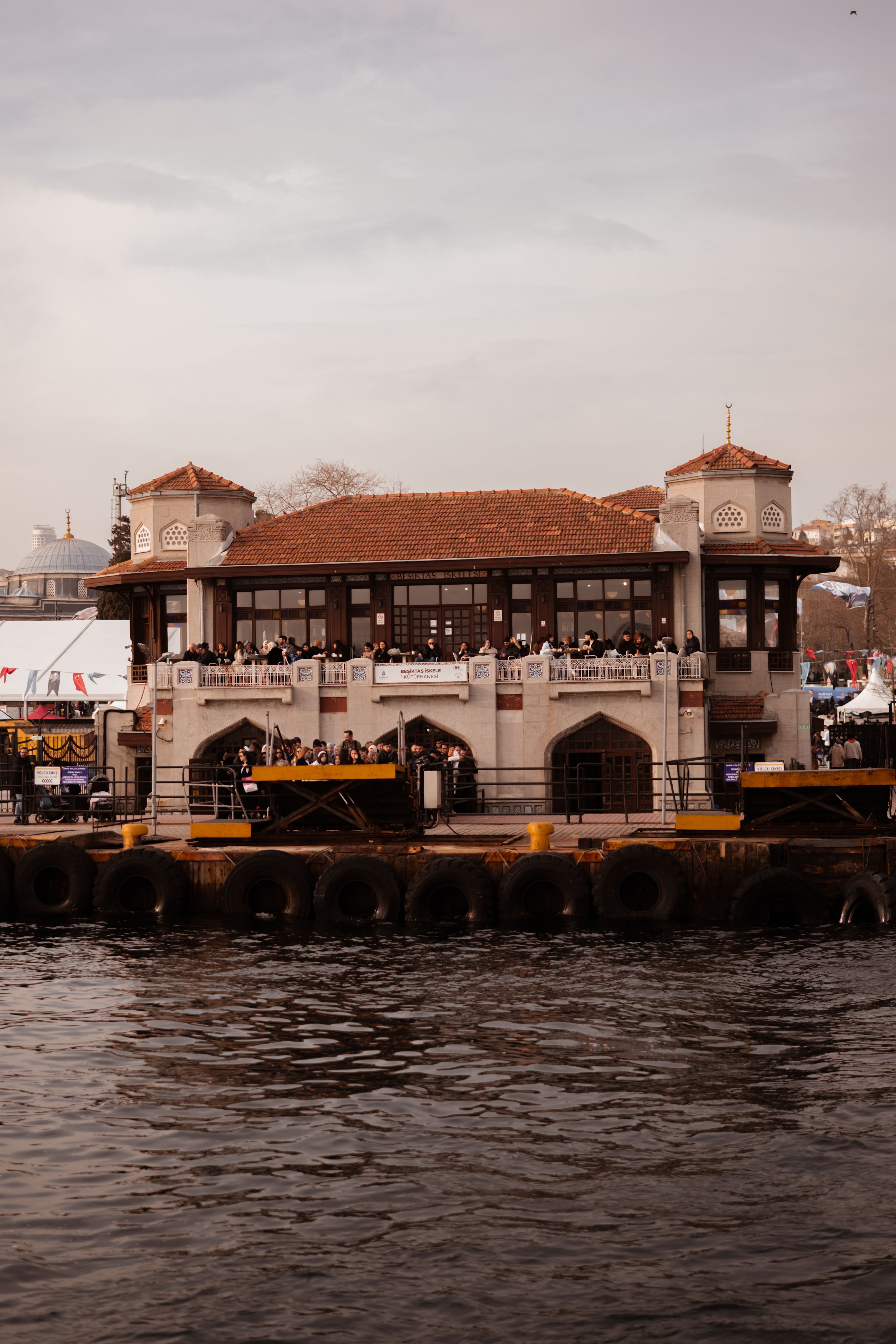 Beautiful view of Üsküdar Pier in Istanbul with historical architecture by the sea.
