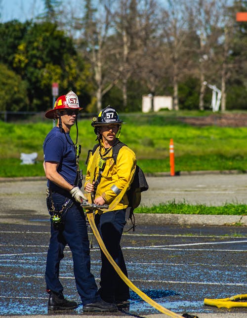 Two firefighters are standing next to each other
