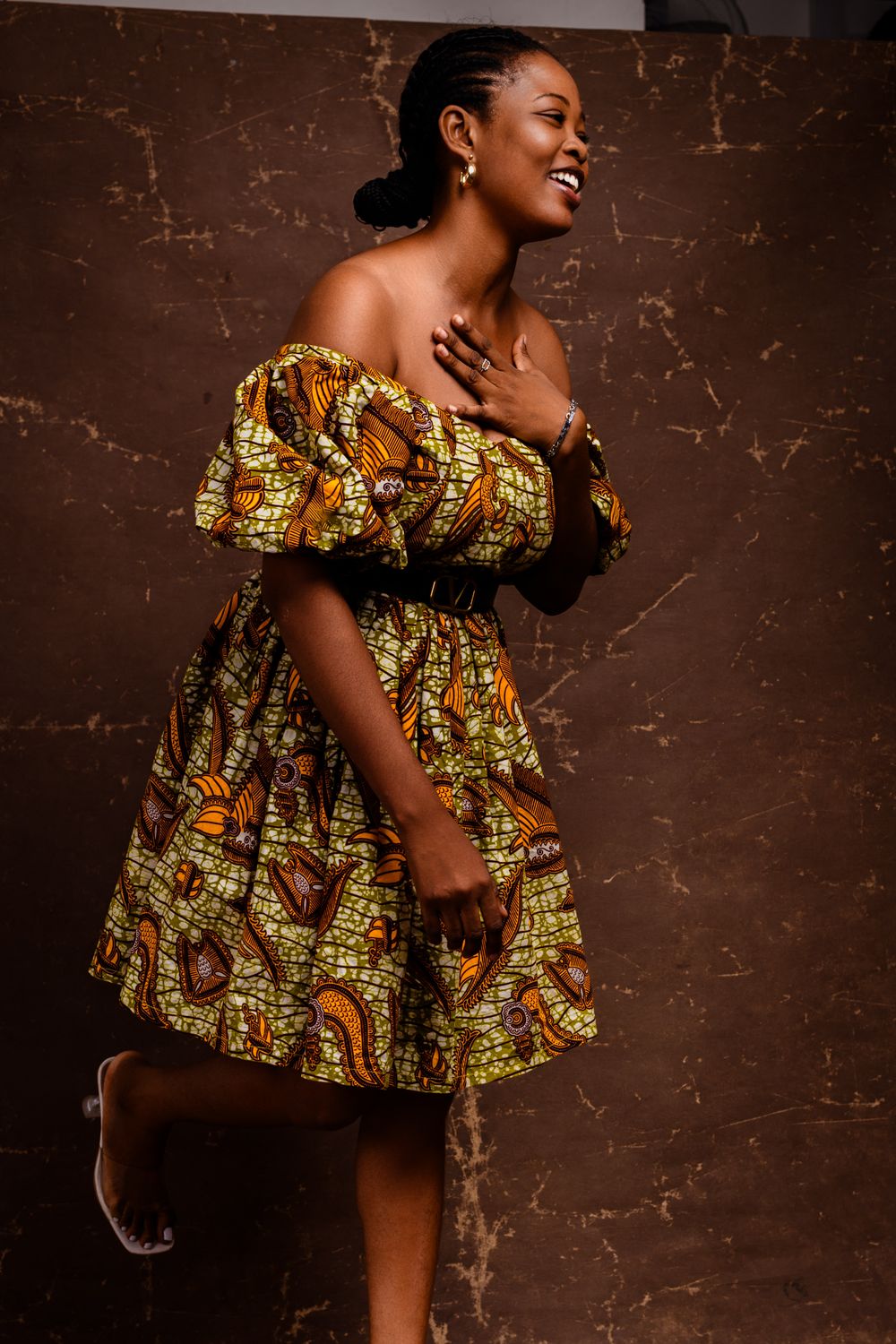 Model Against Patterned Background Smiling Model in Patterned Dress · Free Stock Photo