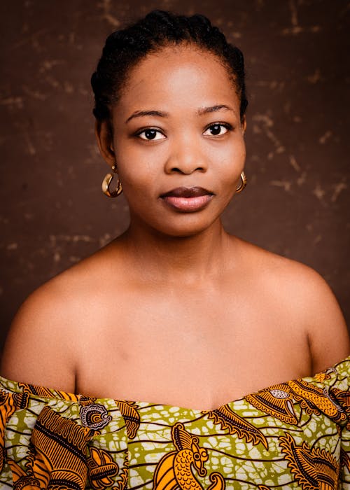 A woman in an african dress posing for a portrait