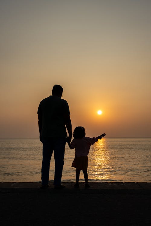 Girl with Father on Beach at Dawn