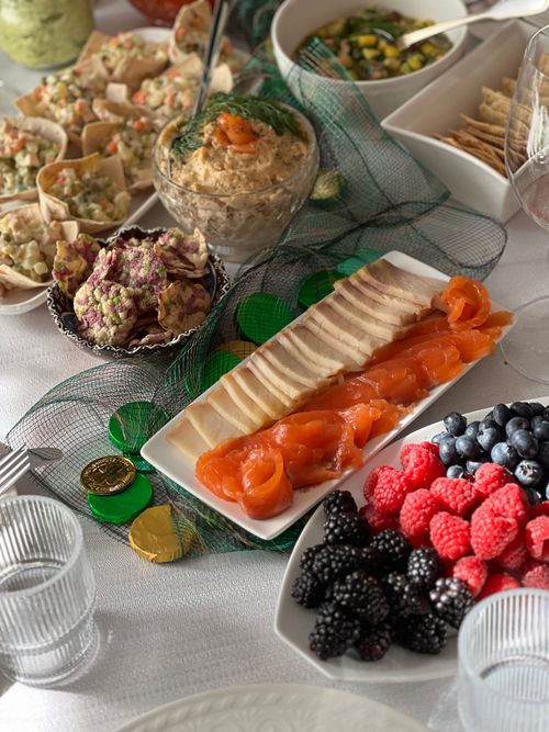 Free A delicious spread of sliced salmon, fresh berries, and assorted appetizers on a festive table setting. Stock Photo