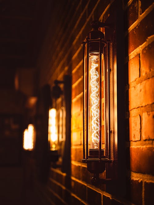 старомодный фонарь, висящий на кирпичной стене
