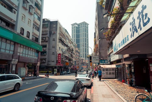 A city street with cars parked on the side