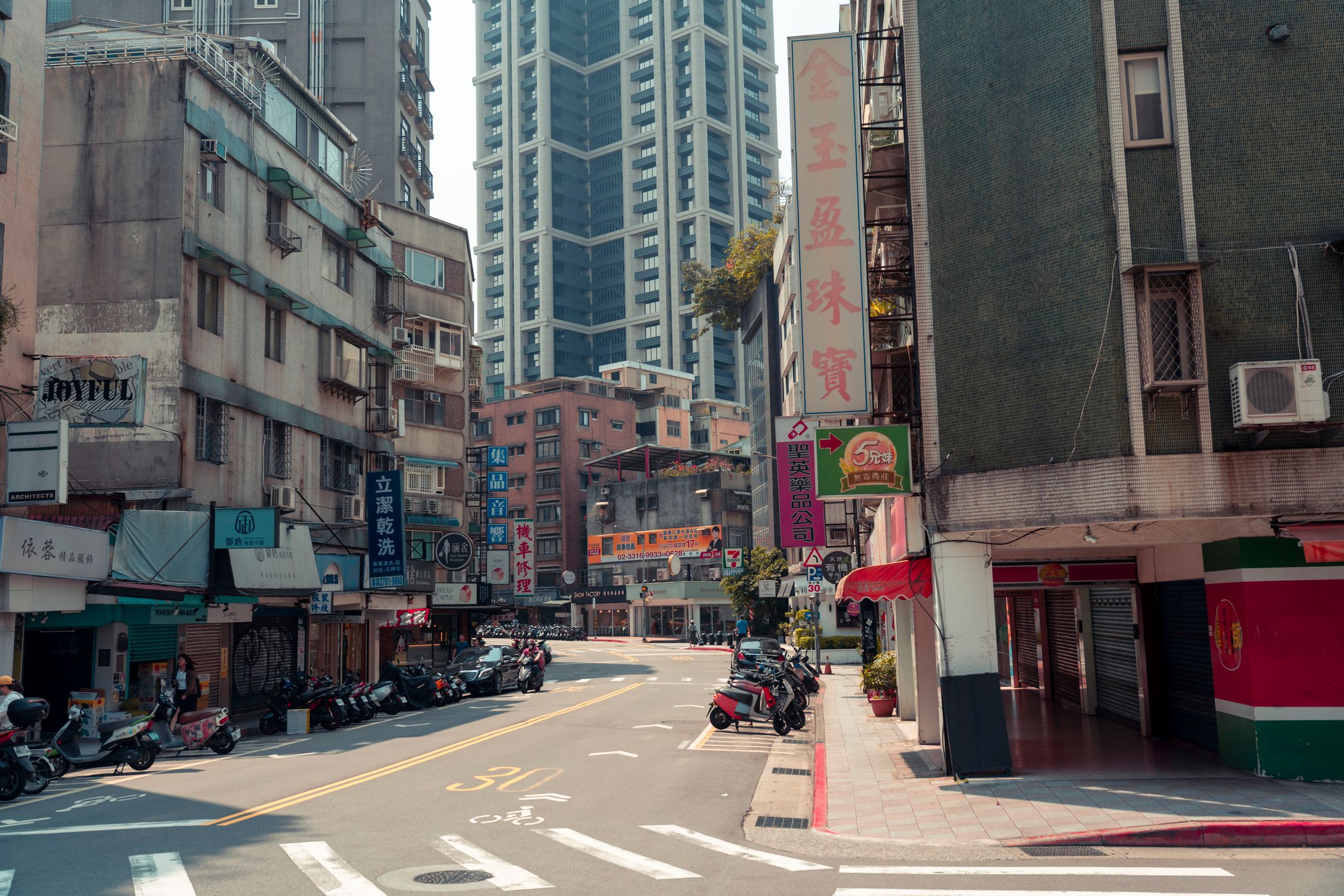 A bustling city street with skyscrapers and vibrant urban life