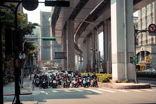 A group of motorcycles are parked on the street