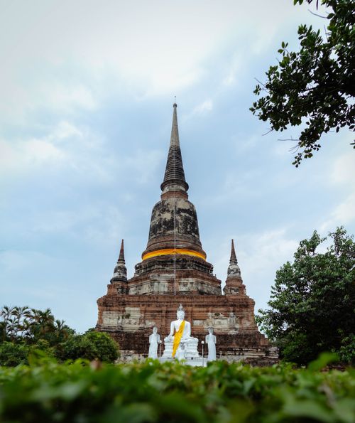 Free Serene view of Wat Yai Chai Mongkhon pagoda with Buddha statues in Ayutthaya, Thailand. Stock Photo