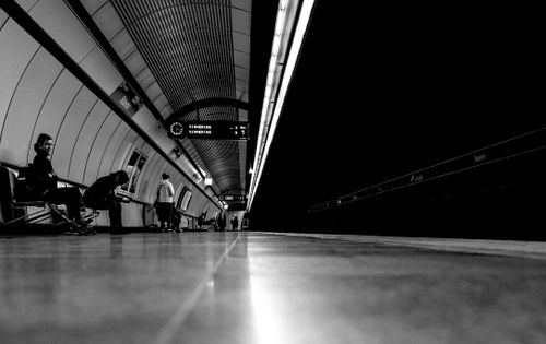 Free Monochrome photo of people waiting at a Vienna subway platform. Stock Photo