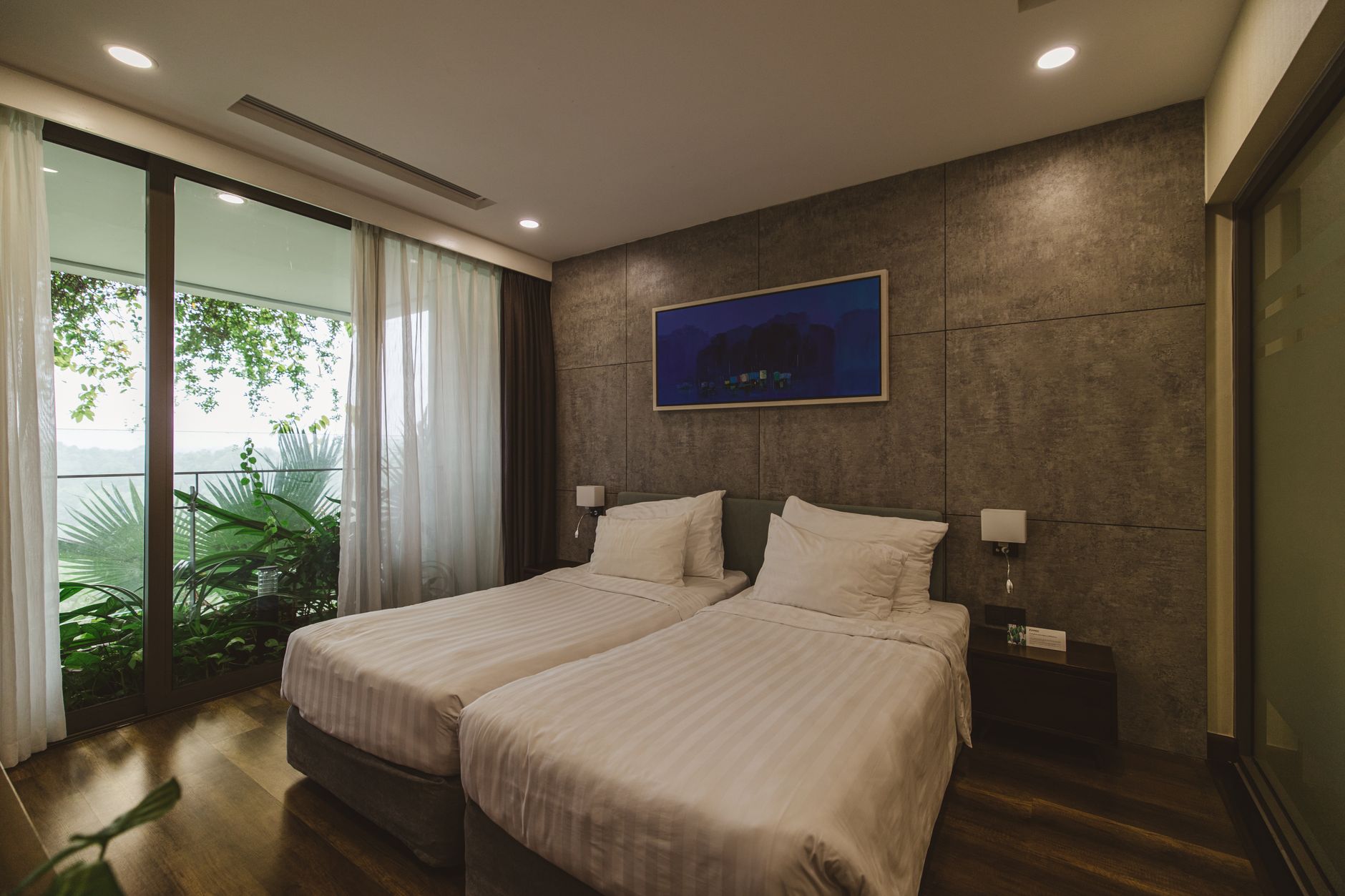 A minimalist luxury medical consultation room with a panoramic view of a global city skyline at dusk.