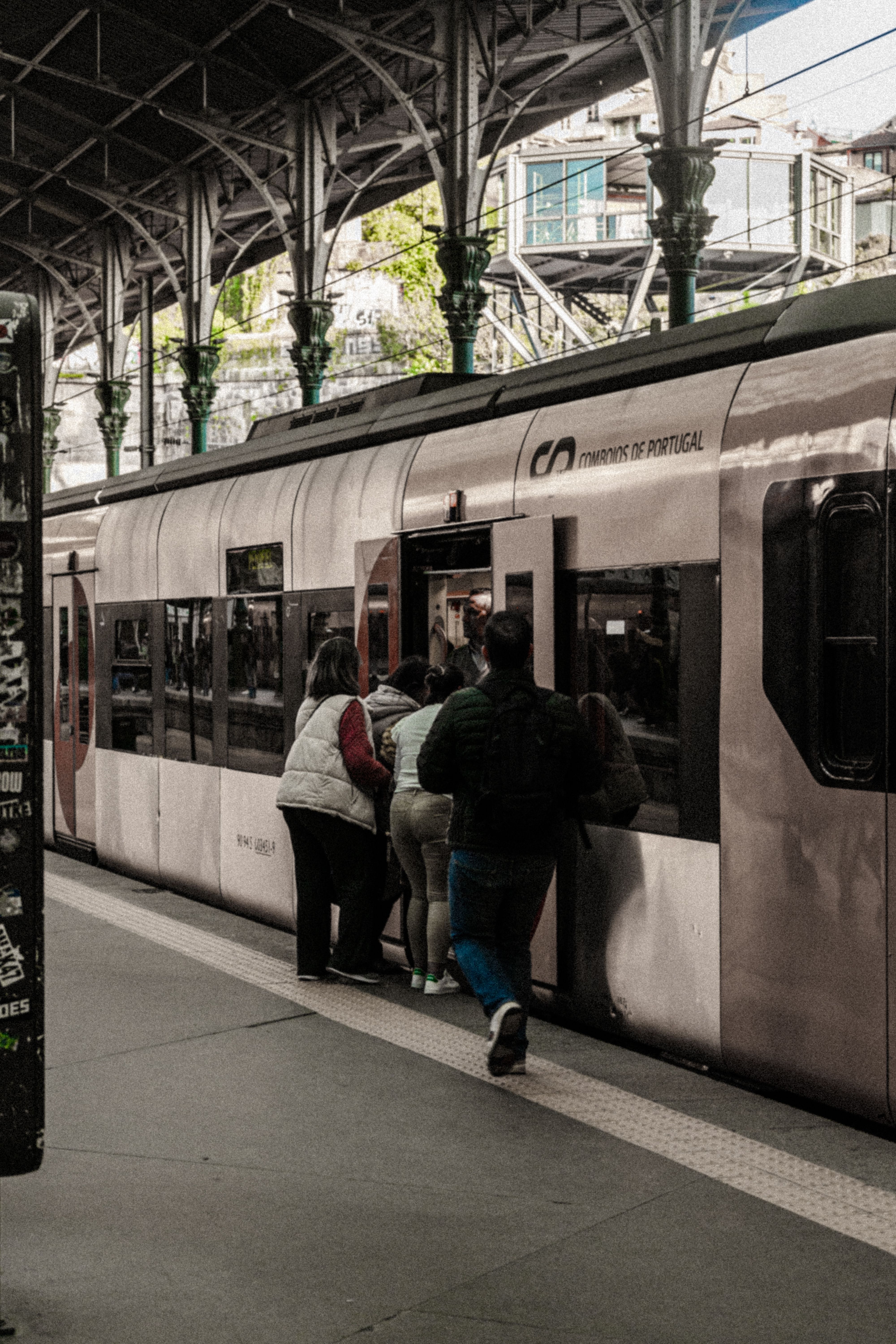 A train is parked at a station with people getting on and off · Free ...
