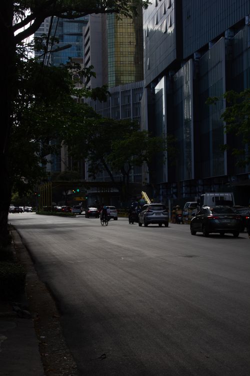 Free City street with modern skyscrapers and low traffic during the evening. Stock Photo