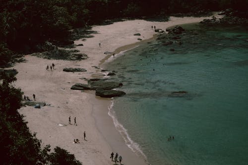 A beach with people on it and a boat