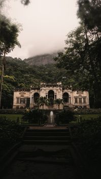 Scenic view of Parque Henrique Lage with mist covering the lush mountains in Rio de Janeiro.