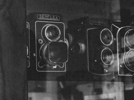 Black and white photo of vintage Semflex cameras in a display in Hanoi, Vietnam.